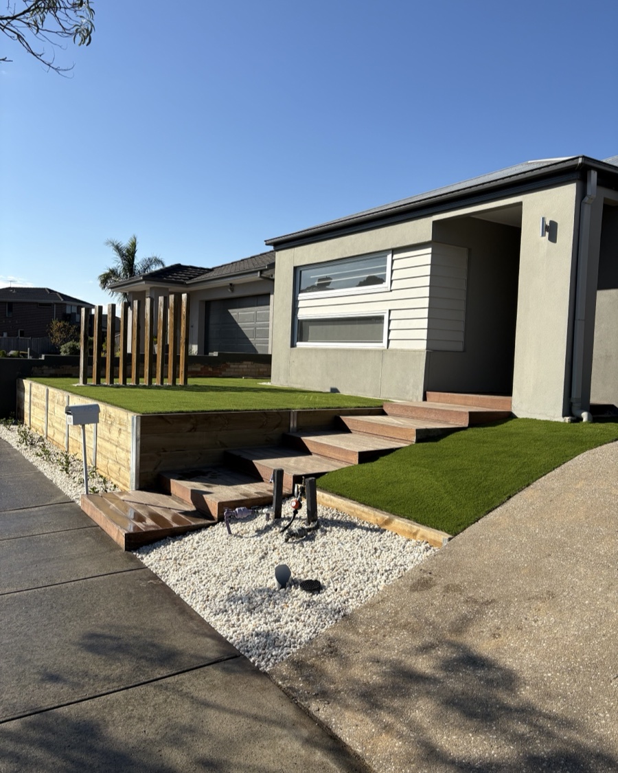Finished terraced front yard with timber retaining wall, fresh turf and timber steps